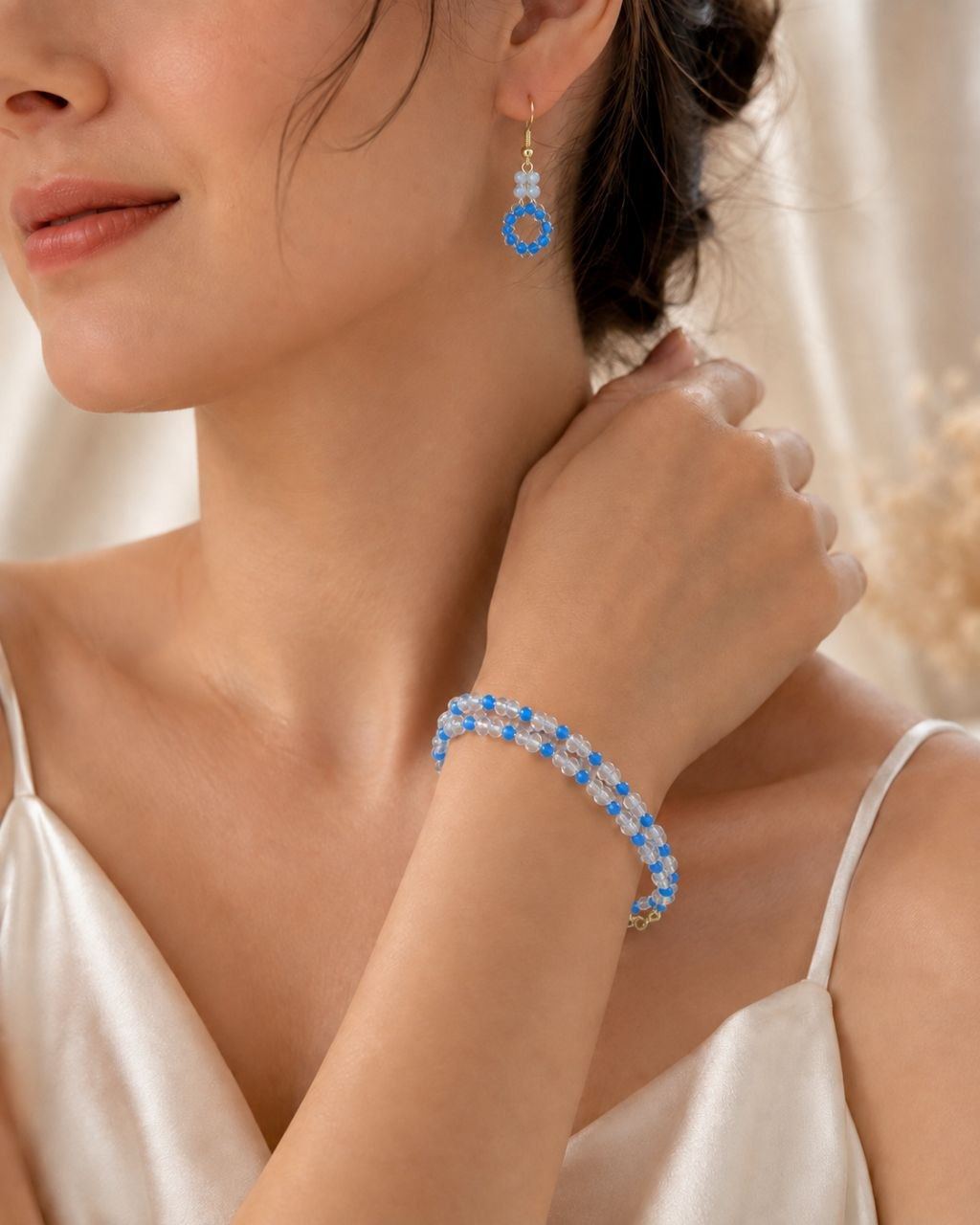 A MARIA’S bracelet and earrings worn on a wrist